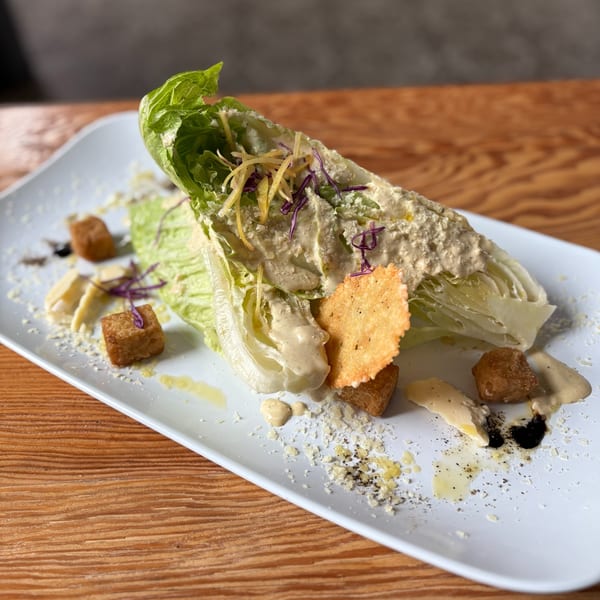 Notch 8's Caesar salad with romaine lettuce, creamy dressing, croutons, cheese, and a cracker.