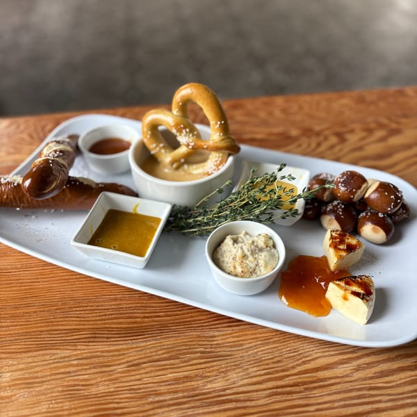 Notch 8's pretzel board with various pretzels, dipping sauces, and grilled brie cheese.